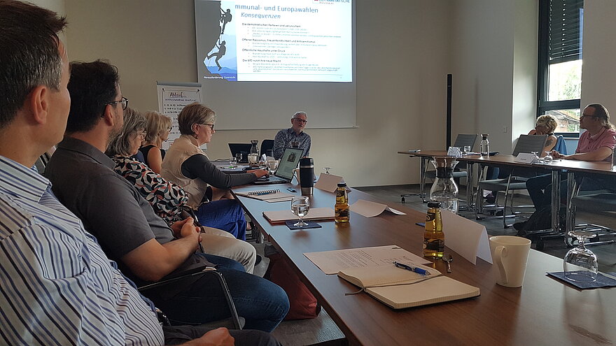 Menschen im Konferenzraum in Frankfurt/Oder hören einem Vortrag von Andreas Kaczynski zu